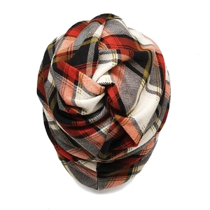 Close-up of red and green plaid snood scarf showing warm knitted fabric texture
