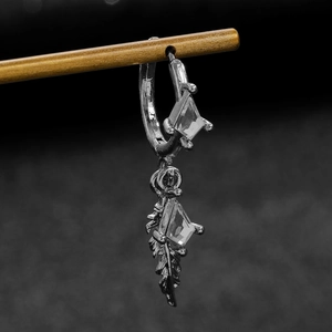 Detail of dark grey feather drop earring featuring inlaid rhombic cubic zirconia stones