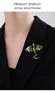 Detailed enamel dragon brooch with green gradient and rhinestones on a black suit lapel