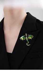 Detailed enamel dragon brooch with green gradient and rhinestones on a black suit lapel