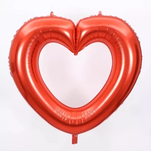 Detail of red hollow heart-shaped foil balloon with metallic luster for party decor