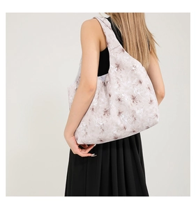 Floral hobo shoulder bag shown on model with vintage flower pattern and spacious design