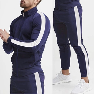 Detail view of navy tracksuit featuring stand collar jacket and white side stripes