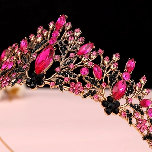 Detail shot of vintage baroque crown with pink crystals and black floral gems