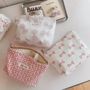 Three sweet floral canvas makeup bags with bows in pink red and purple colors