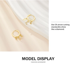 Detailed macro view of S925 sterling silver gold earrings with 5A zircon moon and star charms