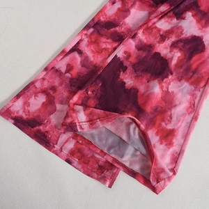 Detail view of pink purple mesh fabric with watercolor print and hem stitching