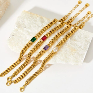 Detailed shot of gold stainless steel Cuban chain bracelets with colored zircon stones