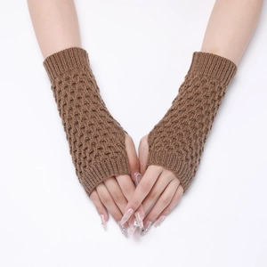 Detail of brown cable-knit fingerless gloves showing pineapple stitch texture and warm material