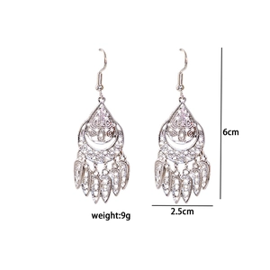 Detail view of ethnic silver drop earrings with dimensions 6cm by 2.5cm and 9g weight