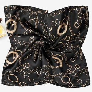 Detail shot of 50cm square silk scarf with golden chain print and PARIS lettering