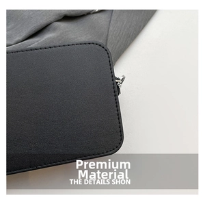 Detailed close-up of premium black lychee leather with neat stitching and silver metal buckle