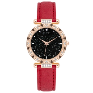 Detail of rose gold diamond bezel and red leather strap on women's starry watch