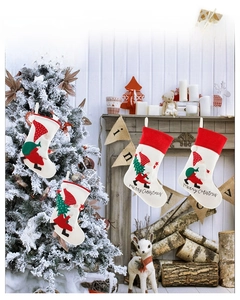 Detail of Nordic style embroidered Christmas stockings with 3D gnome and Santa designs