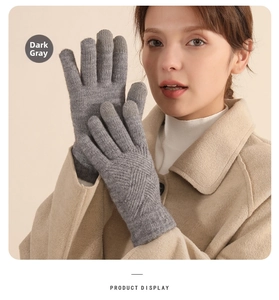 Detail of dark gray knitted glove showing diamond pattern and soft thermal material