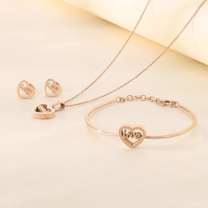Detailed close-up of rose gold jewelry set featuring hollow heart and love engravings