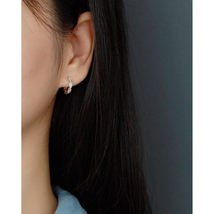 Close-up of S925 sterling silver huggie hoop earring with marquise cubic zirconia