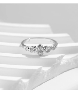 Macro shot of S925 sterling silver ring with five sparkling oval and round diamonds