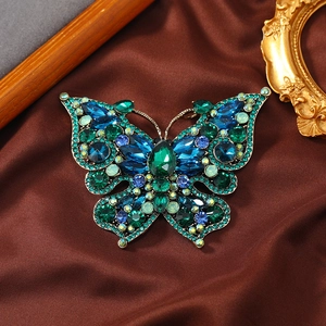 Vintage oversized butterfly brooch with sparkling blue and green crystals on silk
