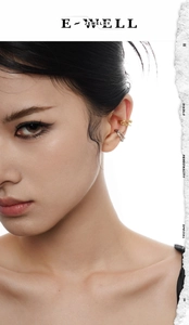 Detailed close-up of double-layered gold and silver textured ear cuffs on a model