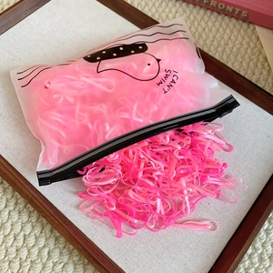Pink elastic hair ties set in a frosted pouch with a minimalist duck design