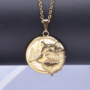 Detailed close-up of 18k gold plated stainless steel wolf head pendant on dark leather