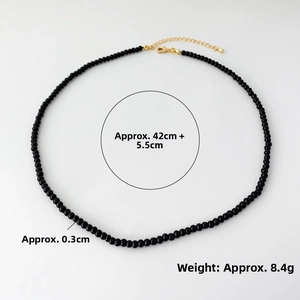 Detail view of 0.3cm black onyx bead necklace with golden lobster clasp and chain extension