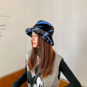 Close-up of zebra pattern plush bucket hat in bright blue and black faux fur texture