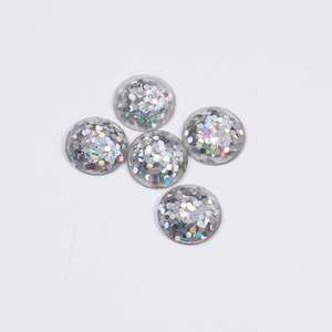Macro detail of five circular resin pieces with vibrant holographic colorful glitter inside