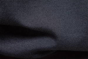 Close-up of premium dark grey fleece fabric texture with soft twill weave pattern