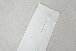 Detail view of the long sleeve cuff featuring a functional thumbhole design in white