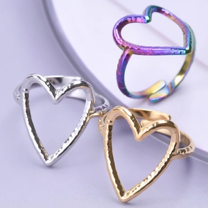 Three-piece set of heart-shaped open rings with hammered texture in gold, silver, and rainbow