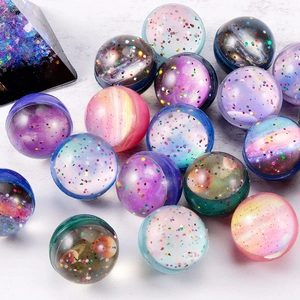 Detailed close-up of cosmic galaxy bouncy balls with colorful nebula patterns and glitter