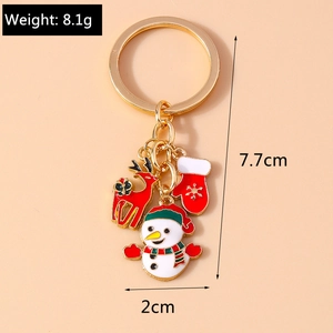 Detailed view of Christmas keychain with elk, snowman, and glove pendants weighing 8.1g