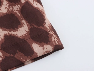 Detailed macro view of leopard print twill fabric texture and high-quality stitching