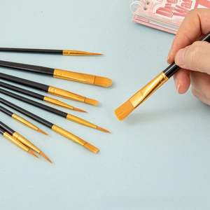 Detail shot of ten professional nylon artist paintbrushes with various brush head shapes