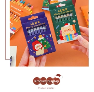 Close-up of 8-color Christmas crayon set featuring festive Santa and reindeer illustrations