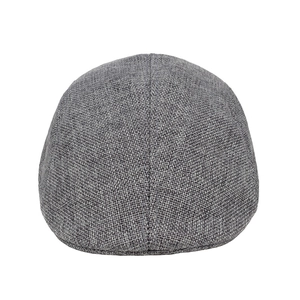 Detailed macro view of the grey linen fabric texture on a flat ivy cap for men
