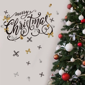 Detail of self-adhesive Merry Christmas wall decals with gold bows on grey wall