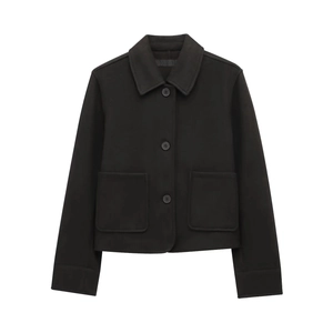 Detailed view of black cropped coat featuring a classic collar and soft wool-like texture