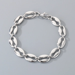 Detailed view of silver coffee bean puff mariner links with lobster clasp closure