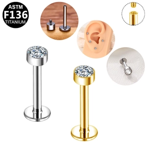 Detail of G23 titanium labret studs with internal threads and cubic zirconia inlays