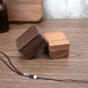 Detail of square black walnut wood jewelry box with high-quality natural grain finish