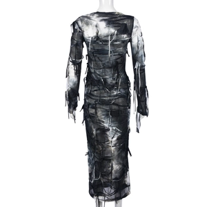 Macro detail of tie-dye mesh dress showing torn fabric and lace-up back design