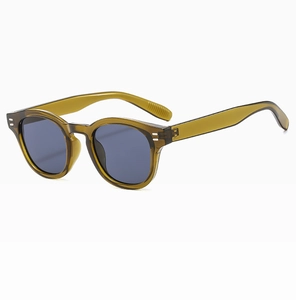 Close-up of olive green oval sunglasses with classic metal rivets and tinted lenses