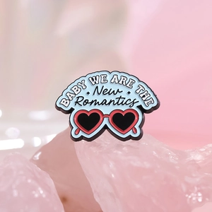 Blue heart-shaped sunglasses enamel brooch with New Romantics slogan on pink crystal