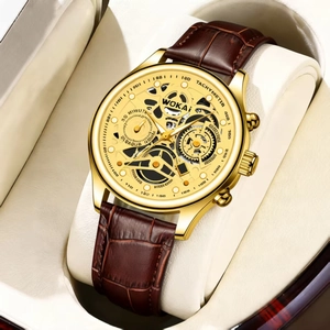 Macro shot of gold-plated case with skeleton dial and brown leather strap in a watch box