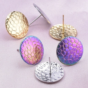 Macro detail of 304 stainless steel stud earrings with honeycomb and hammered textures
