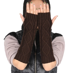 Detail of dark brown cable-knit arm warmers with thumb holes and long fingerless design