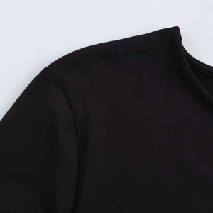 Close-up of black long sleeve bodysuit showing shoulder seams and neckline detail